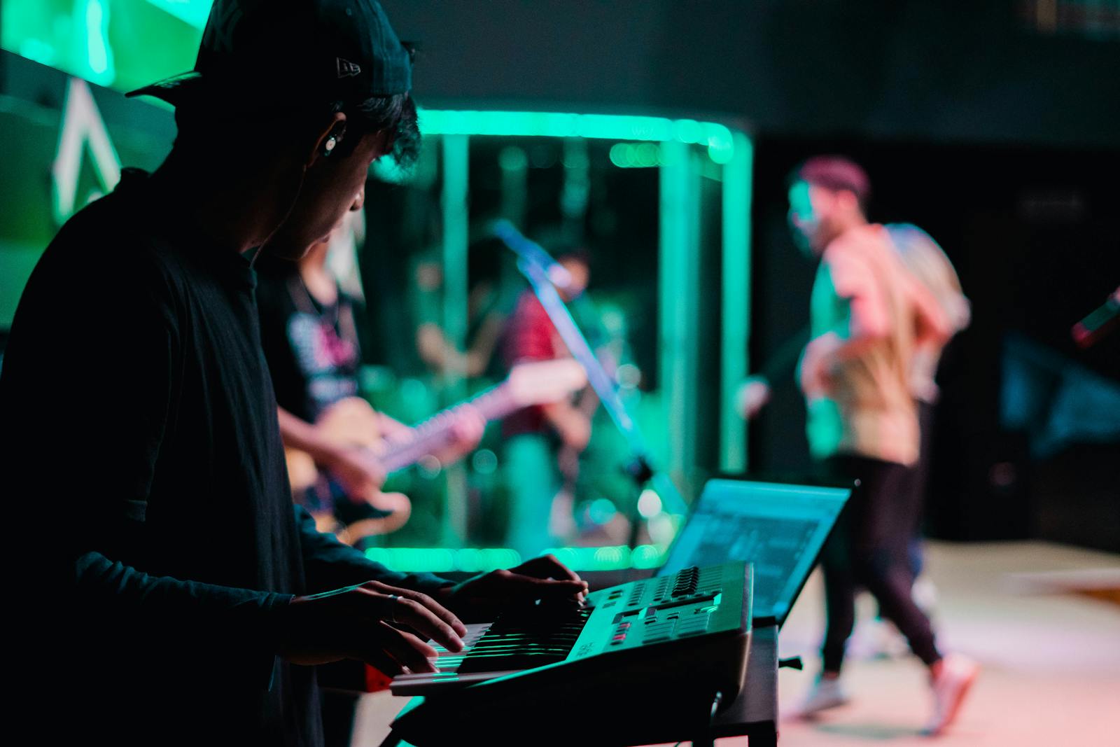 A dynamic live concert scene featuring a keyboardist and band performing on stage, highlighting musical talent.