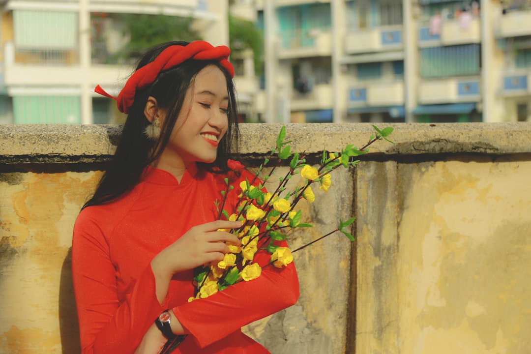 a woman in a red dress holding a bouquet of flowers