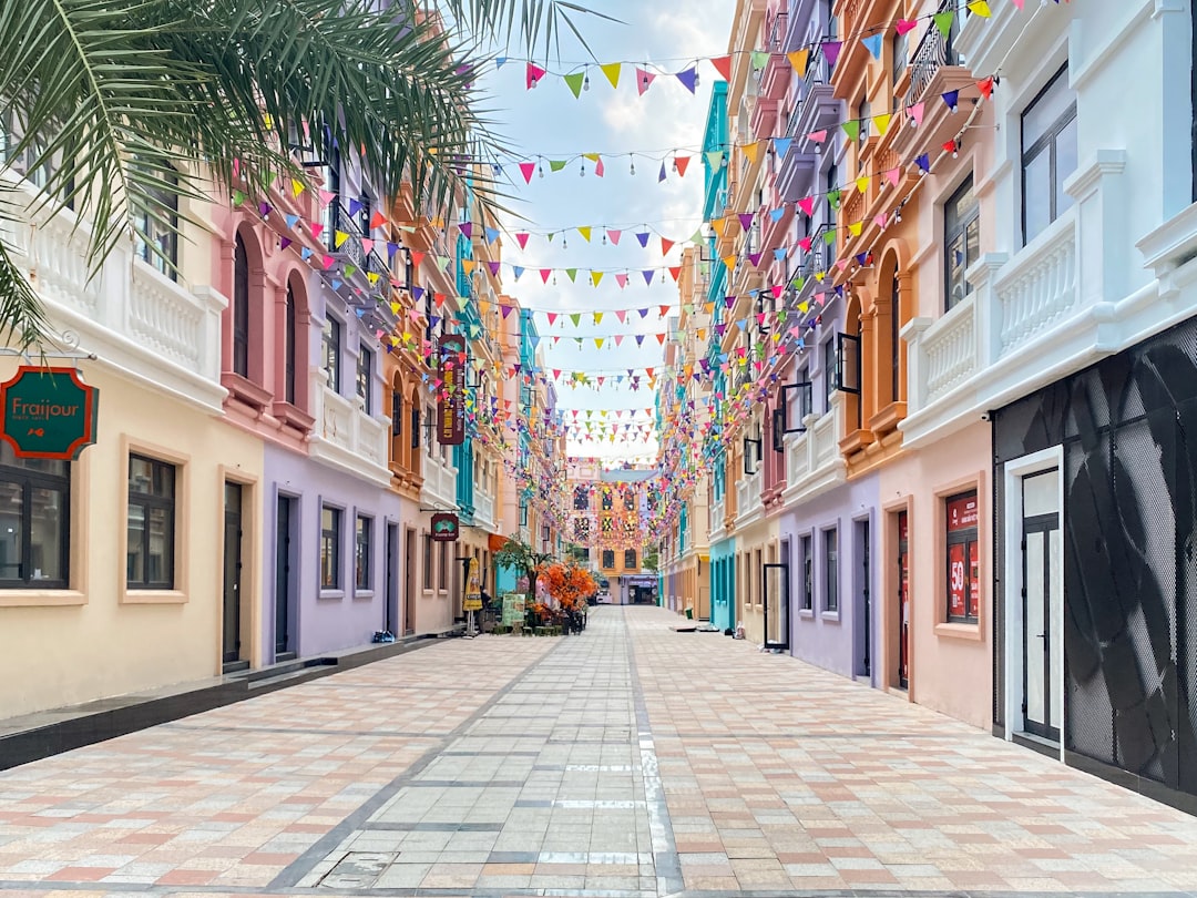 A street lined with buildings and palm trees
